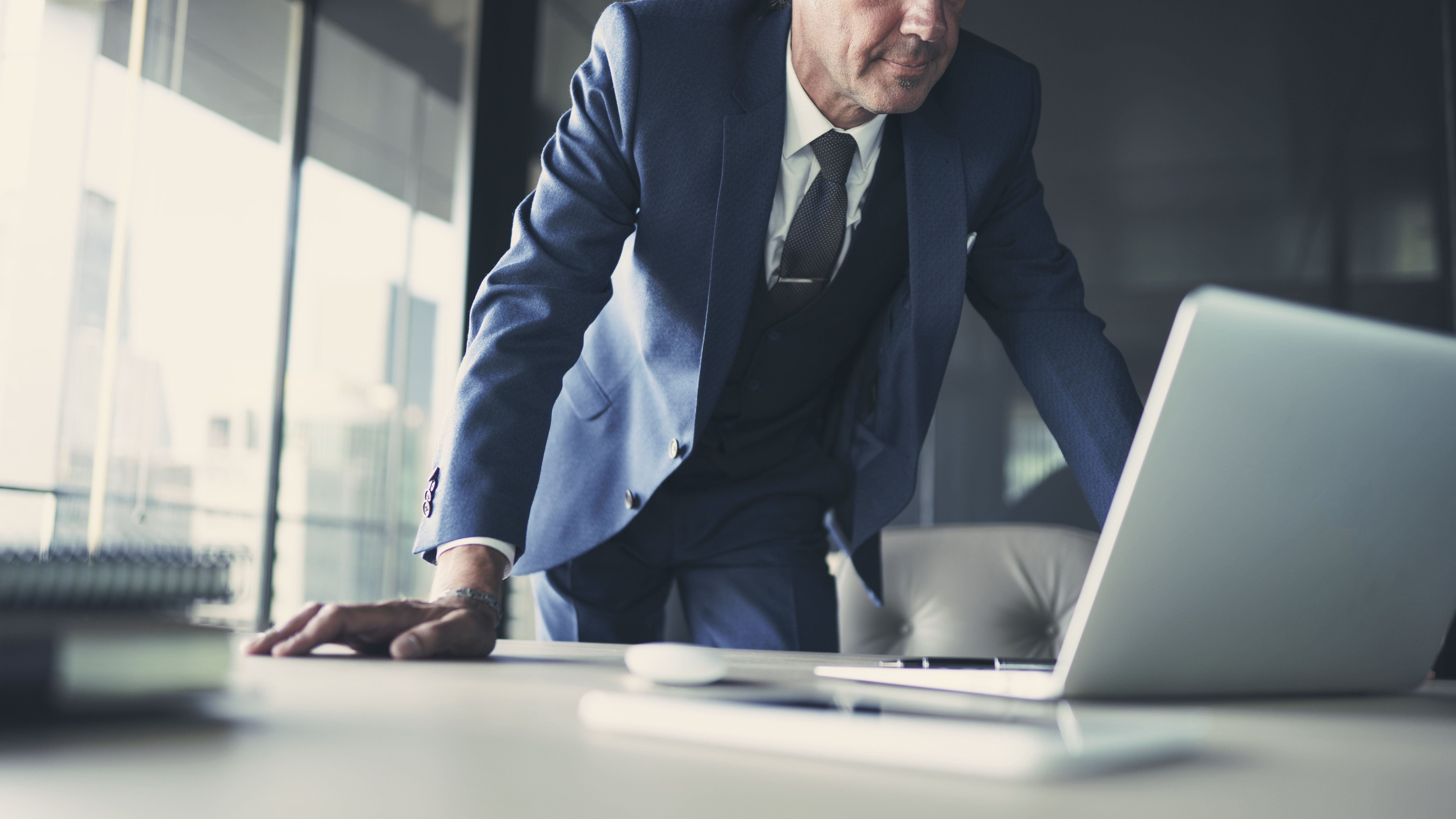 man in suit over desk